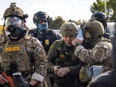 img of Border Patrol Official's Tear Gas Attack on Chicago Crowd Sparks Outrage and Legal Questions