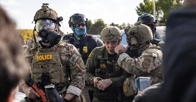 img of Border Patrol Official's Tear Gas Attack on Chicago Crowd Sparks Outrage and Legal Questions